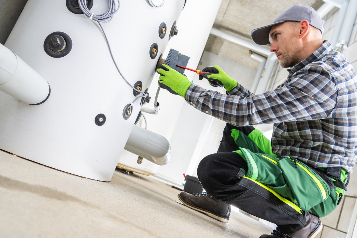 Technician working on a boiler repairs.